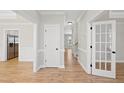 Bright hallway with hardwood floors and white doors at 3128 Gold Dust Ln, Willow Springs, NC 27592