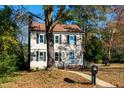 Two-story beige house with black shutters and a landscaped yard at 3317 E Jameson Rd, Raleigh, NC 27604