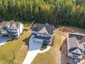 Aerial view of a house and surrounding neighborhood at 613 Darian Woods, Holly Springs, NC 27540