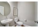 Simple bathroom with pedestal sink and oval mirror at 9516 Woodriver Dr, Zebulon, NC 27597