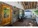 Inviting front porch with rocking chairs and stone accents at 404 W Roanoke Park Dr, Raleigh, NC 27608