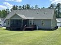 Spacious backyard with a large deck, screened porch, and grassy area at 203 Long Grass Dr, Smithfield, NC 27577