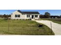 New construction home features a beige exterior, neat landscaping, and a spacious driveway at 29 Pate Landing Dr, Selma, NC 27576