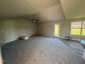 Spacious living room with neutral carpeting, high ceilings, and access to the back patio at 29 Pate Landing Dr, Selma, NC 27576