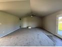 Open living area featuring vaulted ceilings, a ceiling fan, and a door leading outside at 29 Pate Landing Dr, Selma, NC 27576