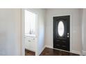 Entryway with powder room and black front door at 407 Eagle Ct, Henderson, NC 27536