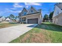 Two-story brick home with a large driveway and landscaped lawn at 407 Eagle Ct, Henderson, NC 27536
