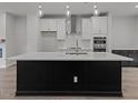 Modern kitchen with large island and stainless steel appliances at 4505 Mint Leaf Ln, Raleigh, NC 27612