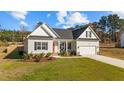 Newly built home with a red front door, two-car garage, and landscaped yard at 80 Black Oak Pl, Spring Lake, NC 28390