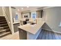 Modern kitchen with gray cabinets, quartz countertops, and stainless steel appliances at 109 Lone Star Dr, Louisburg, NC 27549