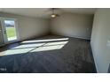 Bright living room featuring gray carpet and access to a patio at 186 Pate Landing Dr, Selma, NC 27576