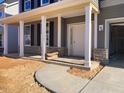 Covered porch with white columns and stone base at 347 N. Maple Walk Dr # 211, Garner, NC 27529