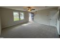 Bright living room with neutral carpeting and access to the front entrance at 36 Holly Grove Ln, Lillington, NC 27546