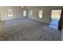 Spacious living room with grey carpet, vaulted ceiling, and lots of natural light at 45 New Bethel Ct, Lillington, NC 27546