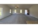 Spacious living room with grey carpet, vaulted ceiling, and lots of natural light at 45 New Bethel Ct, Lillington, NC 27546