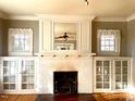 Living room fireplace with built-in shelving and hardwood floors at 504 Summitt Dr, Sanford, NC 27330