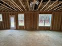 Unfinished room with three windows and exposed framing at 9133 Phoenix Ct, Spring Hope, NC 27882