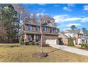 Two-story brick home with gray accents, a two-car garage, and a landscaped lawn at 105 Valleycruise Cir, Garner, NC 27529
