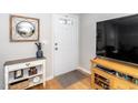 Bright and airy entryway with large TV and console table at 1320 S State Street # D, Raleigh, NC 27610