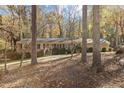 Ranch home nestled among tall trees, offering curb appeal at 161 Pine Cone Dr, Oxford, NC 27565