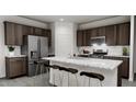 Modern kitchen with stainless steel appliances and island at 1739 Aspen River Lane, Apex, NC 27502