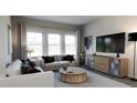 Relaxing living room with comfortable seating and large TV at 1739 Aspen River Lane, Apex, NC 27502
