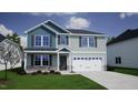 Two-story house with blue and gray siding, stone accents, and a two-car garage at 20 Calabria Ct, Franklinton, NC 27525