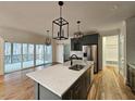 Modern kitchen with a large island, stainless steel appliances, and gray cabinets at 4025 Hamlets Chapel Rd, Pittsboro, NC 27312