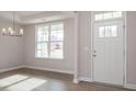 Bright dining room with hardwood floors and a chandelier at 405 Reinsman Ct, Mebane, NC 27302