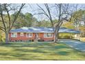 Newly renovated brick ranch house with a carport and large yard at 6506 Garrett Rd, Durham, NC 27707