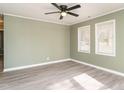 Spacious bedroom with light green walls and wood-look flooring at 808 Trail One, Burlington, NC 27215