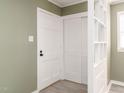 Bright entryway with white door, closet, and built-in shelving at 808 Trail One, Burlington, NC 27215