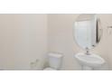 Convenient powder room with pedestal sink and oval mirror at 1137 Middlecrest Dr, Rocky Mount, NC 27804