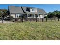 House exterior showcasing a large front yard and black fence at 297 Denvale Dr, Selma, NC 27576