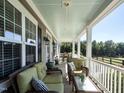 Relaxing front porch with wicker furniture, offering views of the backyard at 297 Denvale Dr, Selma, NC 27576