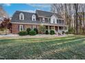 Brick two-story house with a large front porch and landscaped yard at 4027 Green Forest Ct, Rocky Mount, NC 27804