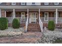 Brick walkway leads to a charming front porch with white railings at 4027 Green Forest Ct, Rocky Mount, NC 27804