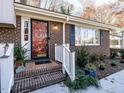 Brick front entry with red door and white railings at 4209 Redington, Raleigh, NC 27609