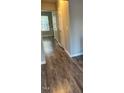 Hallway with light grey walls and wood-look flooring at 67 Red Ln, Raleigh, NC 27606