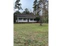 House exterior showcasing a spacious yard and covered porch at 6232 Dawn Dr, Hurdle Mills, NC 27541