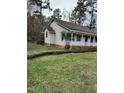 Side view of the house, highlighting its brick facade and landscaping at 6232 Dawn Dr, Hurdle Mills, NC 27541