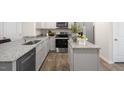 Modern kitchen with granite countertops and stainless steel appliances at 8658 Brixton Shay Dr, Raleigh, NC 27616