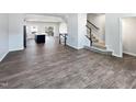 Open concept living room with hardwood floors and a view of the kitchen at 901 Arnold Place Dr, Fuquay Varina, NC 27526