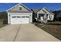 Gray sided ranch home with a two car garage and landscaping at 115 Hunterwood Pl, Benson, NC 27504