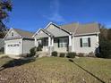 Gray sided ranch home with stone accents and landscaping at 115 Hunterwood Pl, Benson, NC 27504