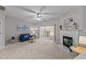Living room with fireplace, blue couch, and sliding glass doors at 125 Arbor Light Rd, Holly Springs, NC 27540