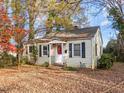 Yellow siding house with a red door and trees at 307 Bickett Blvd, Raleigh, NC 27608