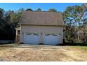 Detached two-car garage with white doors at 340 Cedar Grove Dr, Henderson, NC 27537