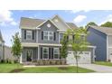 Two-story home with gray siding, white trim, and a two-car garage at 516 Lemon Daisy Ln, Knightdale, NC 27545
