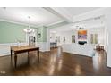 Bright dining room with hardwood floors and view into the living room at 5705 Carmel Valley Ct, Knightdale, NC 27545